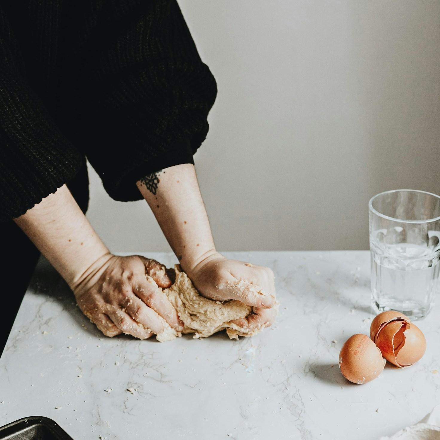 Community members collaborating in a modern kitchen space, sharing recipes and cooking techniques